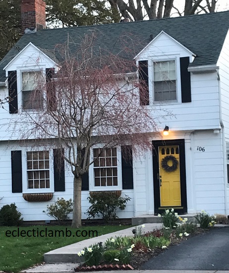 White house yellow door pink tree